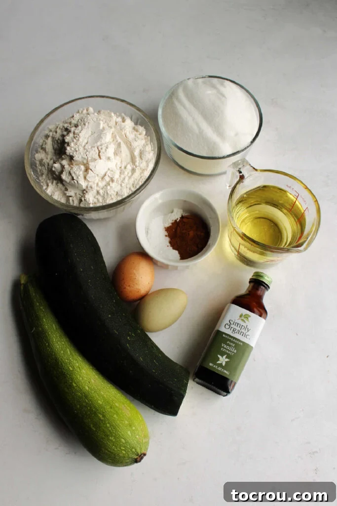 Ingredients ready to be made into zucchini bread, including flour, sugar, eggs, oil, and spices arranged on a counter.