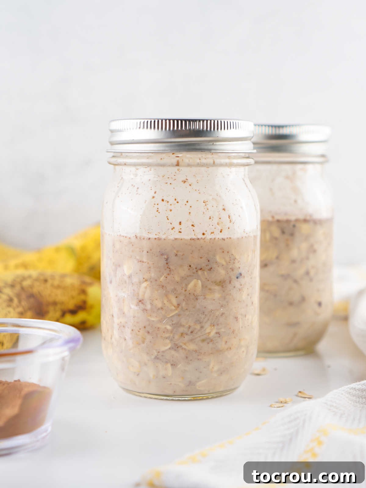 Overnight Banana Bread Bliss 4 Jar with banana bread overnight oats mixture inside, ready to chill and soak.