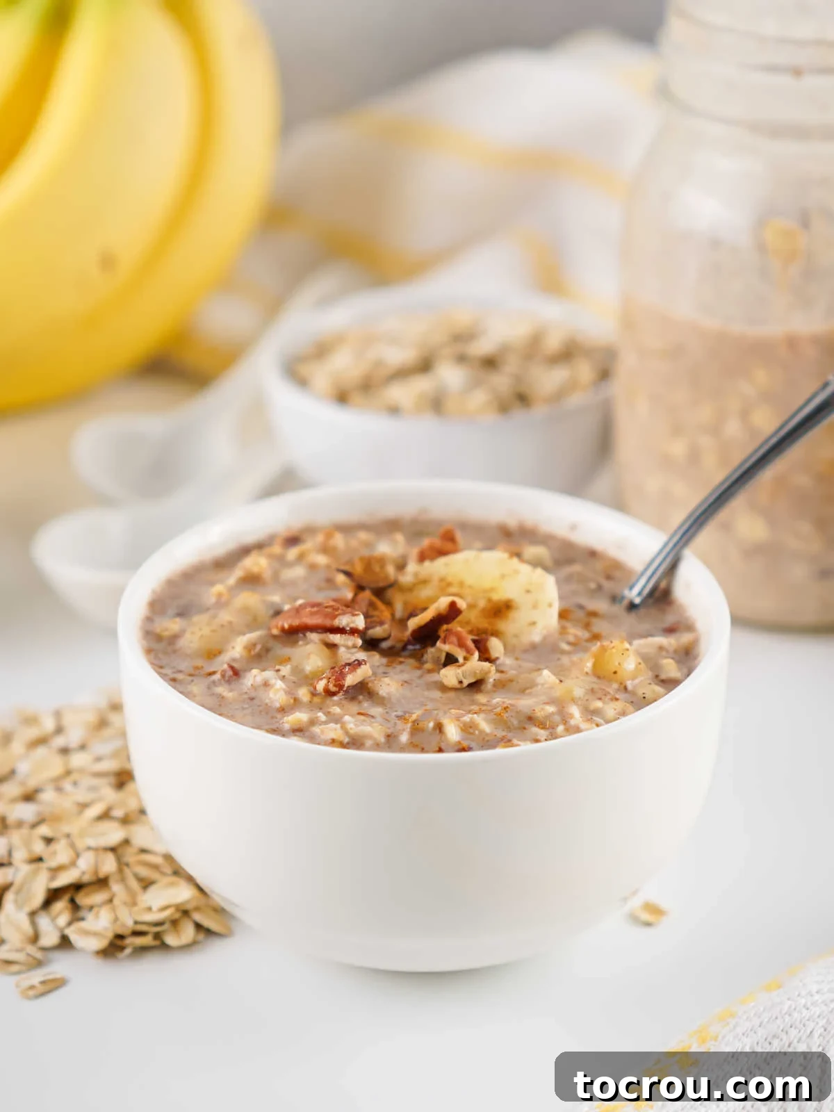 Overnight Banana Bread Bliss 5 Banana bread overnight oats in a bowl topped with chopped pecans and a banana slice, ready to eat.