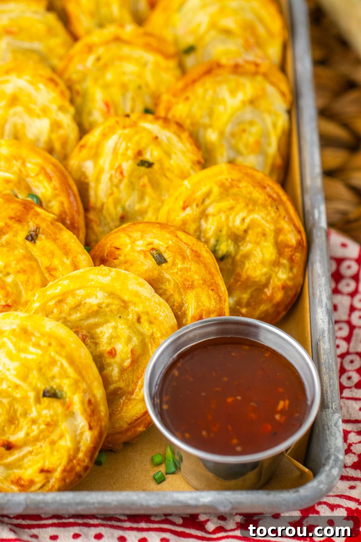 Close up of golden crab rangoon pinwheels, ready to eat.