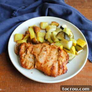 Dinner plate with grilled tandoori chicken with roasted zucchini and curried potatoes.