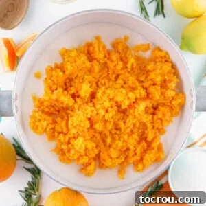 Finely minced pieces of orange in a pot, ready to be made into marmalade.