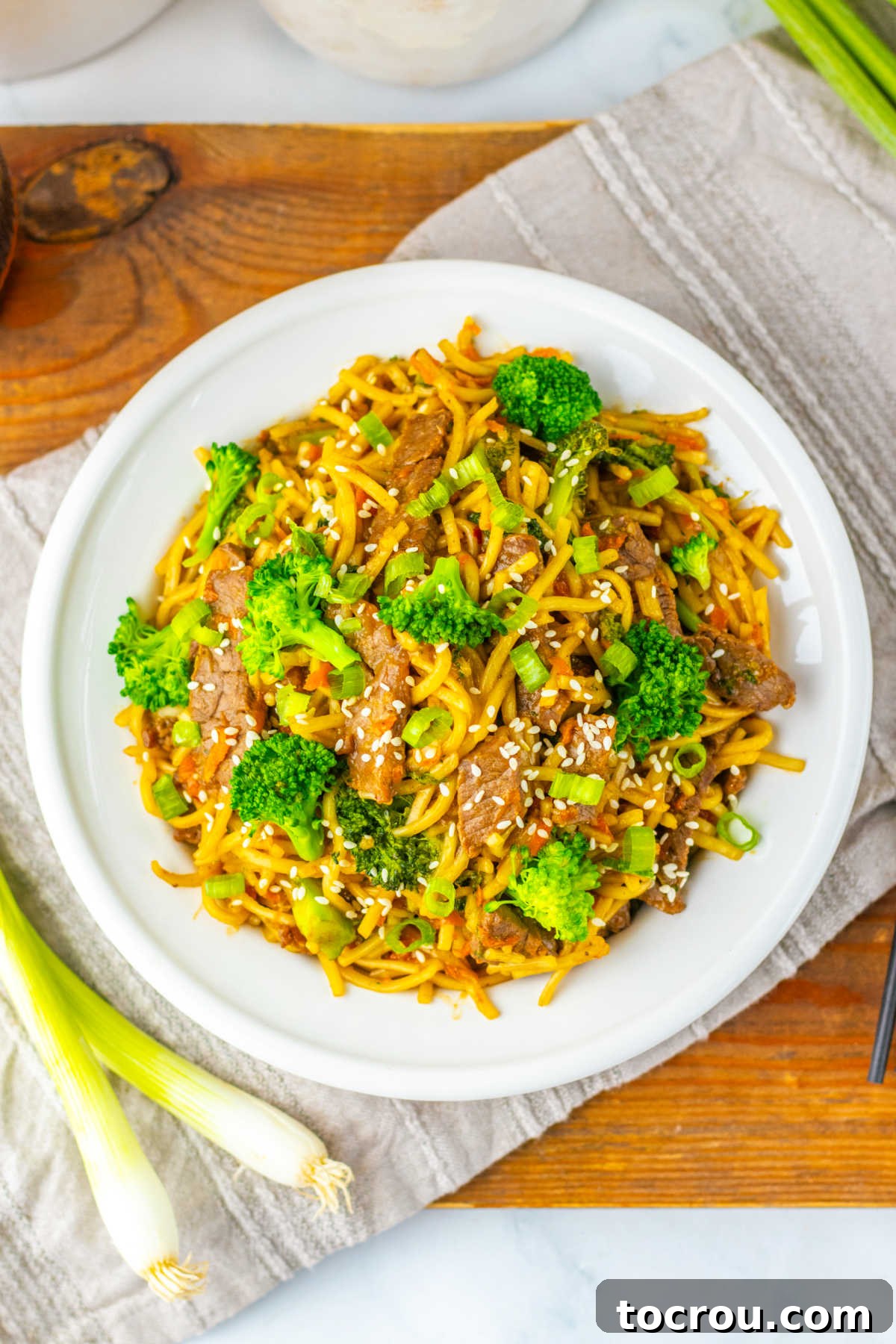 Serving of Beef and Broccoli Lo Mein Plate of beef and broccoli lo mein with sauce coated strips of meat, veggies, and noodles.