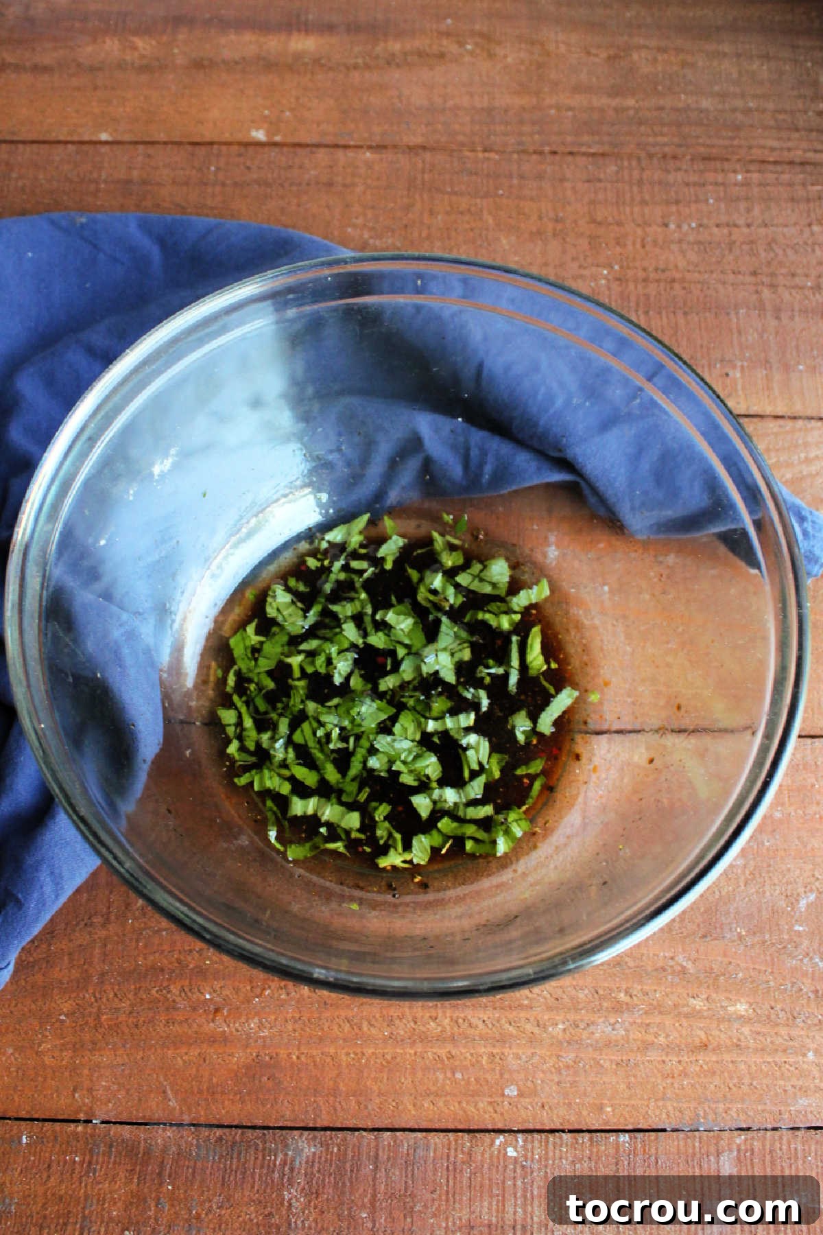 One-Pan Italian Sausage and Roasted Vegetables 5 Bowl of marinade made from balsamic vinegar, oil, garlic, salt, pepper, and fresh herbs.