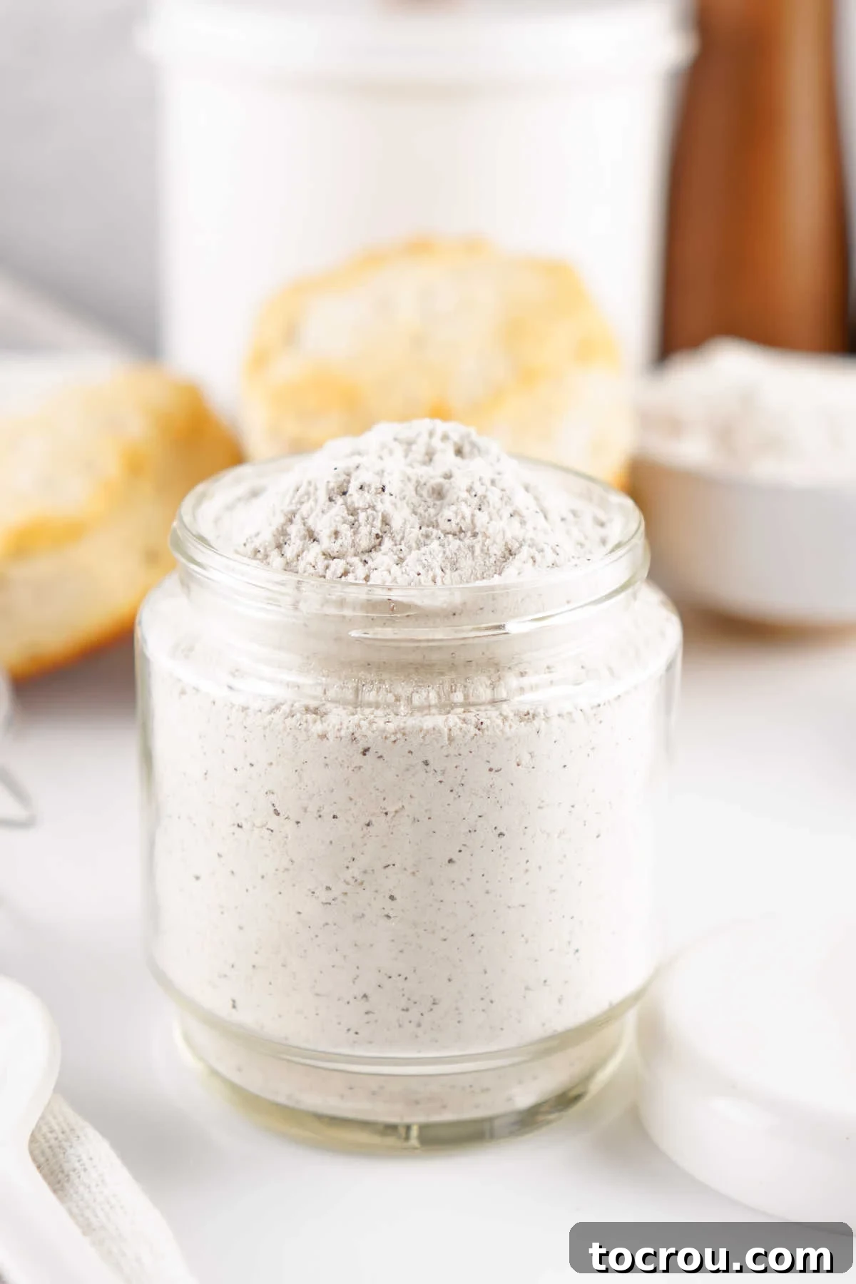 Jar of homemade white gravy mix powder, ready to be used.