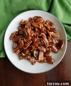 Bowl of shiny homemade candied pecans.