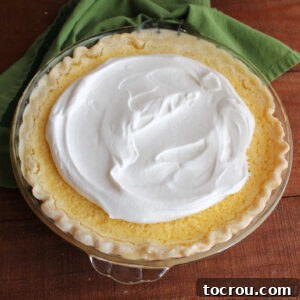 Homemade lemon pie topped with honey whipped cream.