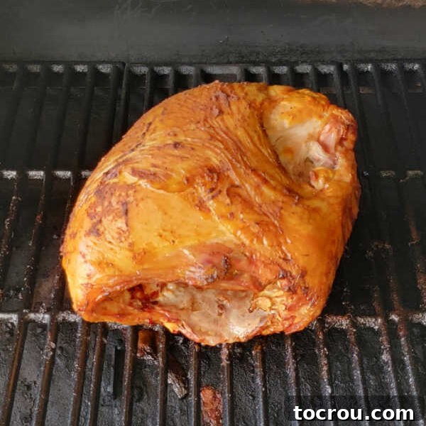 Smoked turkey breast on pellet grill showing deeper color.