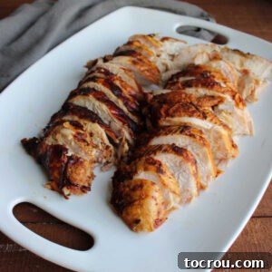 Slices of smoked turkey breast on large serving platter.