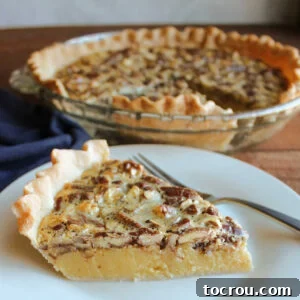 Slice of pie showing smooth sweetened condensed milk and brown sugar filling topped with toasted pecans.