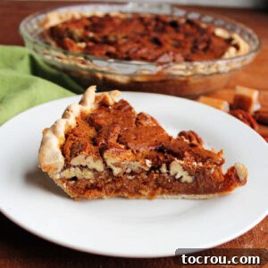 Slice of caramel pecan pie with thick layer of pecans on top and rich caramel layer underneath.