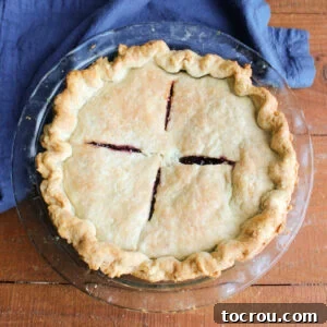 Whole baked double crust pie with nice browning thanks to the foolproof pie crust recipe with an egg and vinegar.