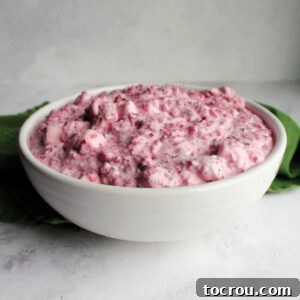 Feast Worthy Thanksgiving Sides 21 A elegant serving bowl filled with a luscious creamy cranberry fluff salad, featuring fluffy marshmallows and tender pineapple chunks, ready to be enjoyed as a refreshing holiday side.