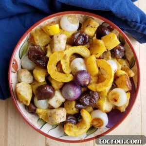Feast Worthy Thanksgiving Sides 25 A rustic serving bowl filled with beautifully roasted fall vegetables, including chestnuts, all glistening in a delectable maple glaze, ready to be enjoyed.
