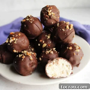 Heirloom Holiday Baking: From Grandma's Cookbook 17 A charming plate adorned with chocolate-dipped coconut bon bons, with one bon bon cut in half to showcase its creamy, delectable coconut center.