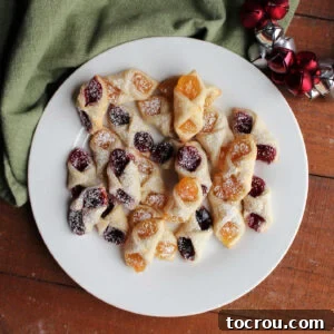 Heirloom Holiday Baking: From Grandma's Cookbook 6 A delightful plate of kolacky cookies, featuring some with sweet raspberry filling and others with tangy apricot filling, all lightly dusted with powdered sugar for a perfect finish.