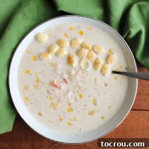 Heirloom Holiday Baking: From Grandma's Cookbook 10 A comforting bowl of Cajun crab chowder, generously topped with a sprinkle of Cajun seasoning and crunchy oyster crackers, ready to offer warmth and flavor.