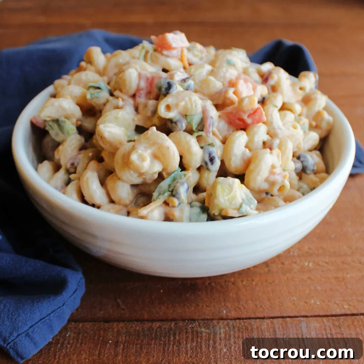 Delicious BBQ Ranch Pasta Salad for summer events Serving bowl filled with bbq ranch macaroni salad with black beans, tomatoes, corn and more.
