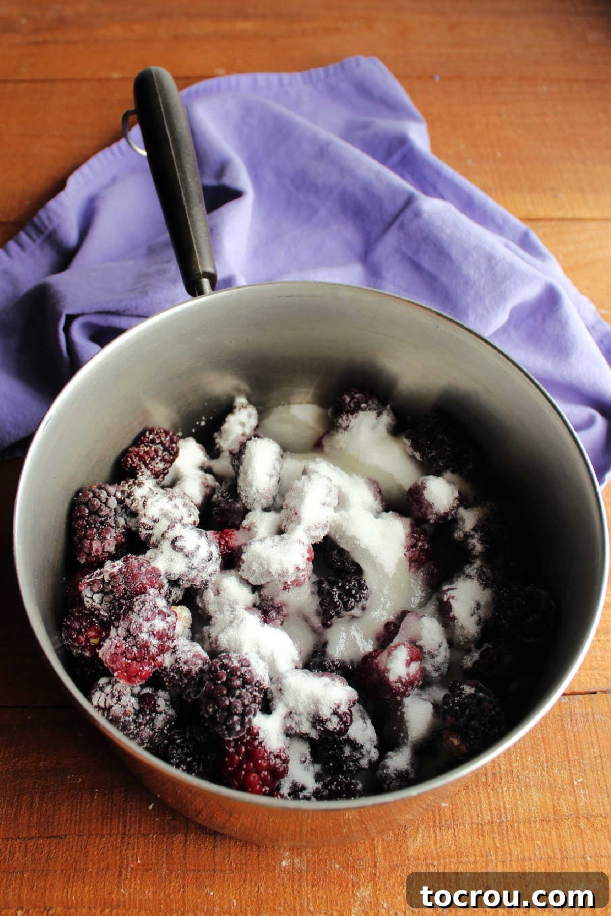 Midnight Berry Indulgence 5 Saucepan filled with frozen blackberries, sugar and lemon juice, ready to cook.