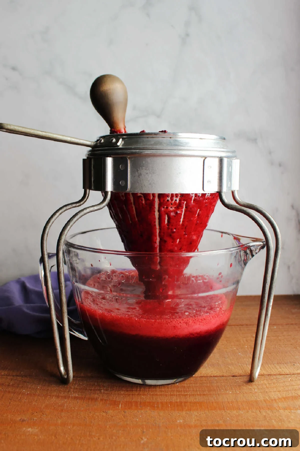 Midnight Berry Indulgence 7 Pressing sweetened blackberry juice out of the berries with the help of an antique food mill.