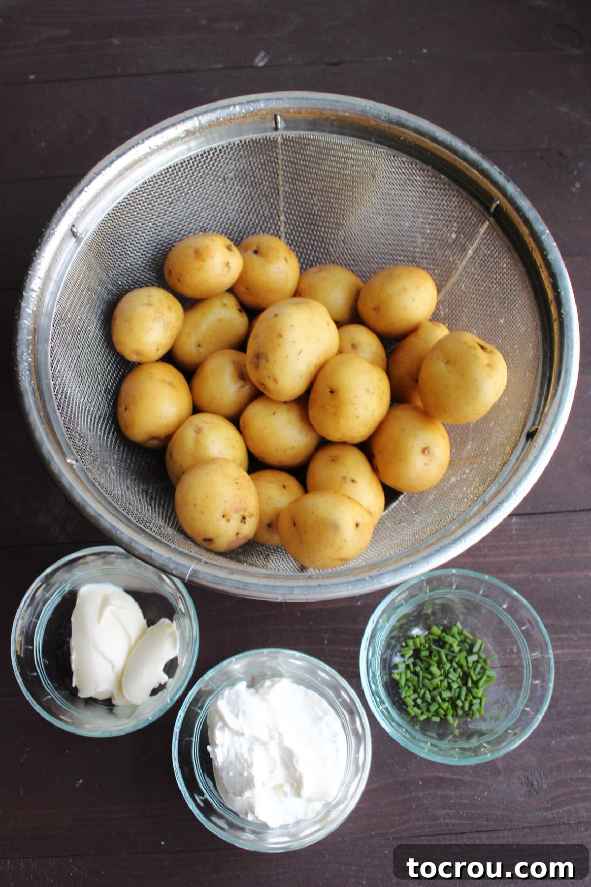Potatoes, butter, sour cream and chives ready to be made into a tasty side dish.