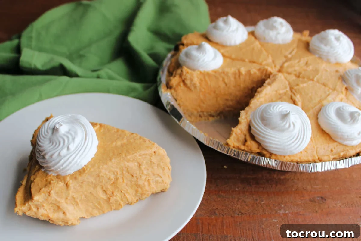 Effortless No-Bake Pumpkin Delight 2 Slice of creamy no bake pumpkin pie on plate next to the remaining pie.