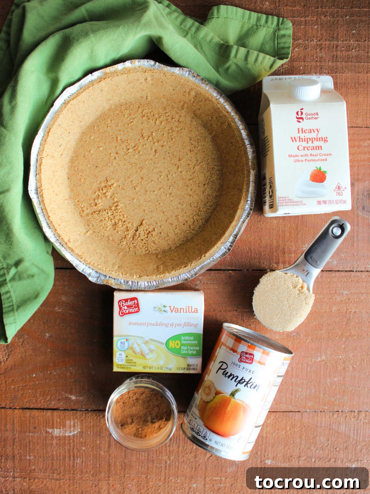 Effortless No-Bake Pumpkin Delight 5 Ingredients including a graham cracker crust, heavy cream, brown sugar, pumpkin puree, pumpkin pie spice and instant vanilla pudding ready to be made into an easy no bake pumpkin pie.