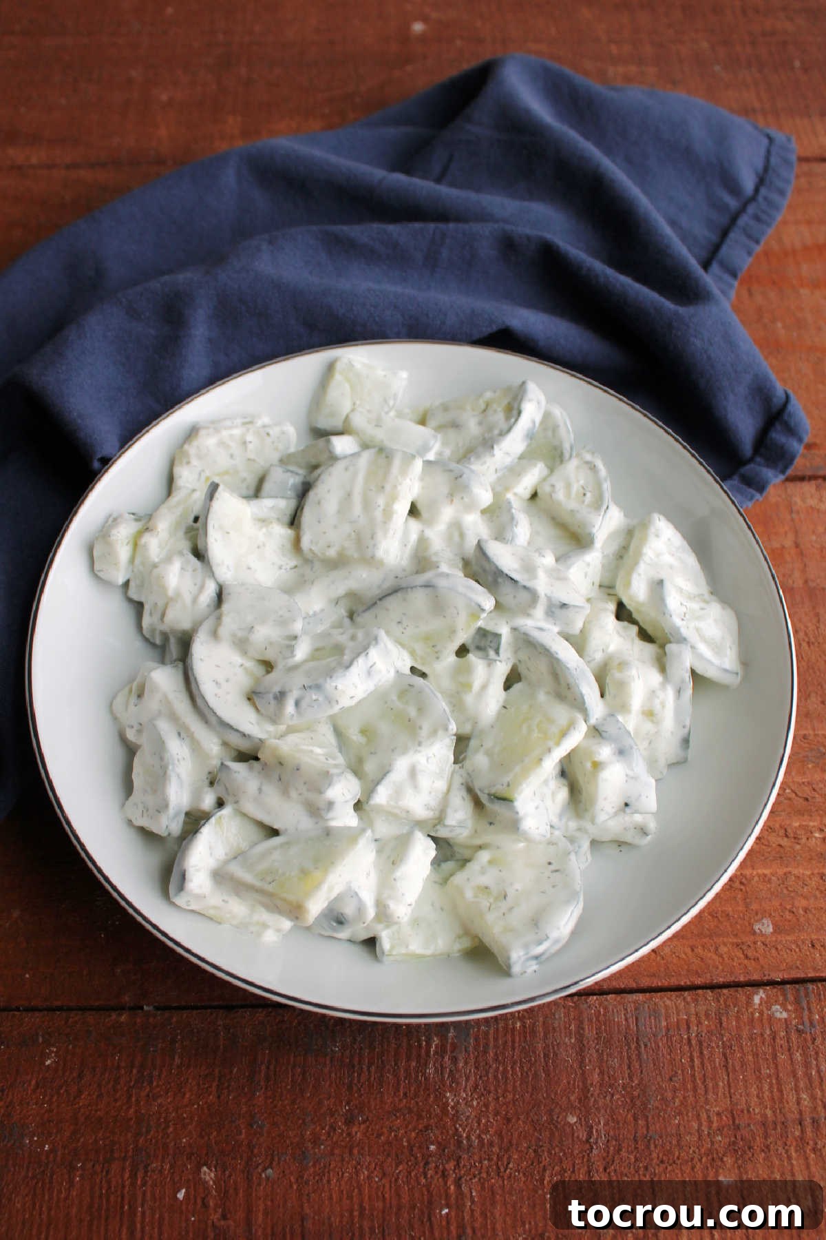 Serving bowl with dilly cucumber salad, ready to eat.
