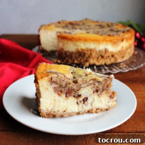 Pecan Pie Cheesecake A beautifully presented slice of pecan pie cheesecake sits in front of the remaining whole cheesecake, ready to be enjoyed.