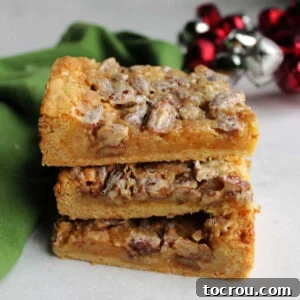 Caramel Pecan Dream Bars A stack of delightful pecan dream bars, featuring a thin, cakey crust and a gloriously gooey pecan topping, promising a sweet and satisfying bite.