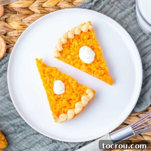 Pumpkin Pie Rice Krispie Treats Two charming wedge-shaped orange Rice Krispie treats, artfully designed to resemble pumpkin pie slices, complete with a dollop of buttercream