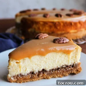 Caramel Pecan Cheesecake A decadent slice of caramel pecan cheesecake, featuring layers of creamy cheesecake, a rich caramel base with pecans, and a luxurious topping of caramel and pecan halves.