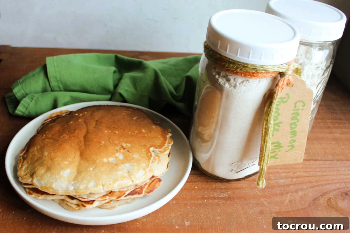 Homemade Cinnamon Pancakes and Mix Plate of homemade cinnamon pancakes next to a couple of jars of homemade cinnamon pancake mix.
