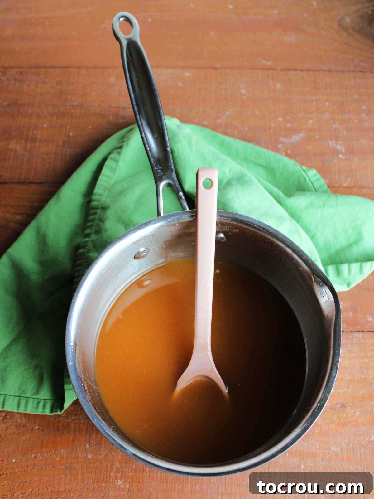 Saucepan with freshly made apple cider syrup inside. 