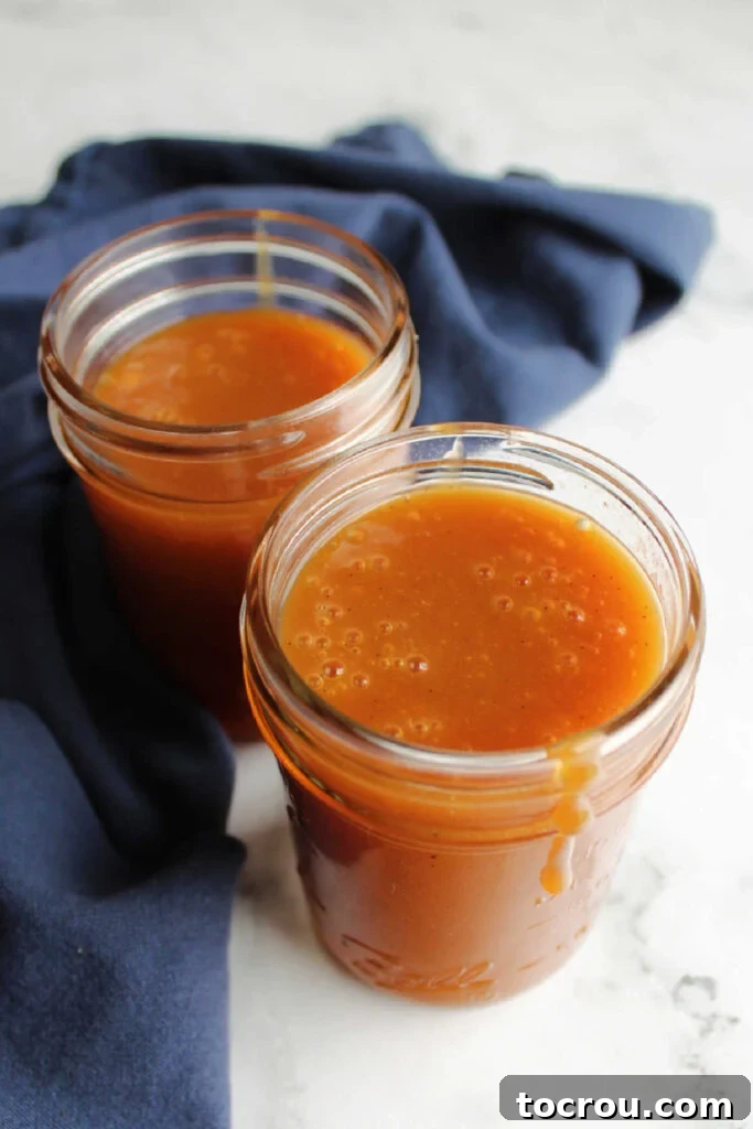 Close-up of a jar filled with deep golden creamy dulce de leche.