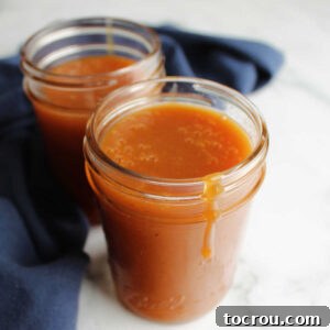 Jars of homemade dulce de leche made from milk and sugar.