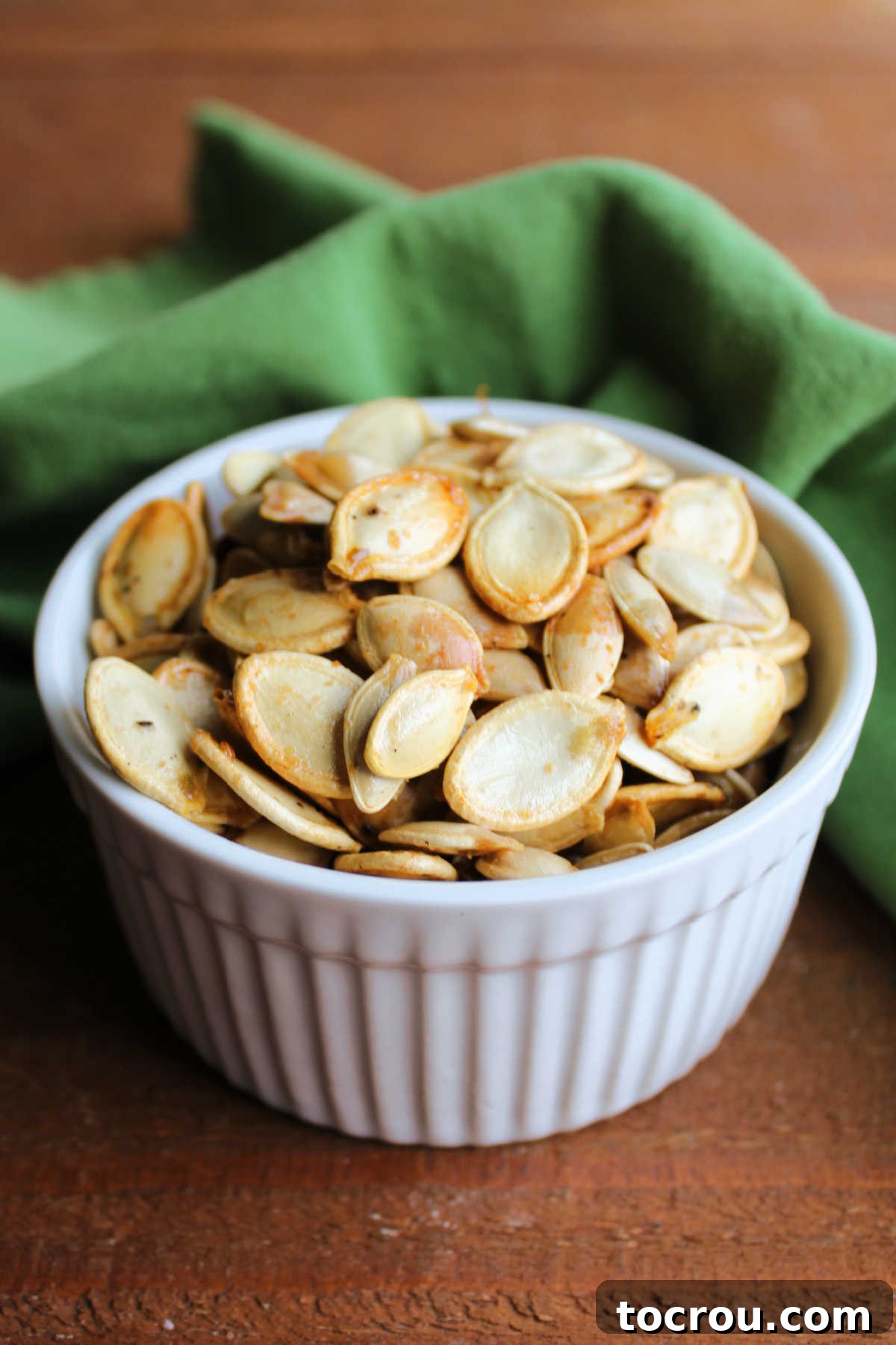 Crunchy Pumpkin Perfection 4 Ramekin filled with roasted pumpkin seeds, ready to eat.