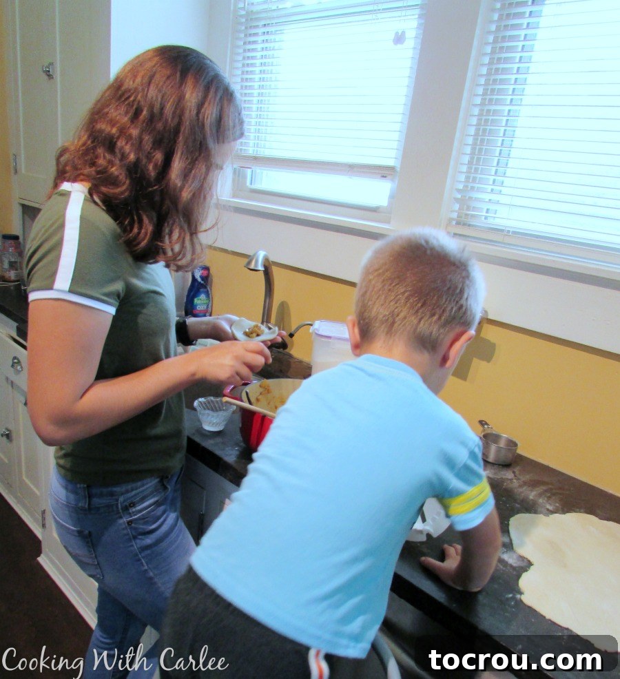 Chloe and Little Dude working on making cajeta empanadas