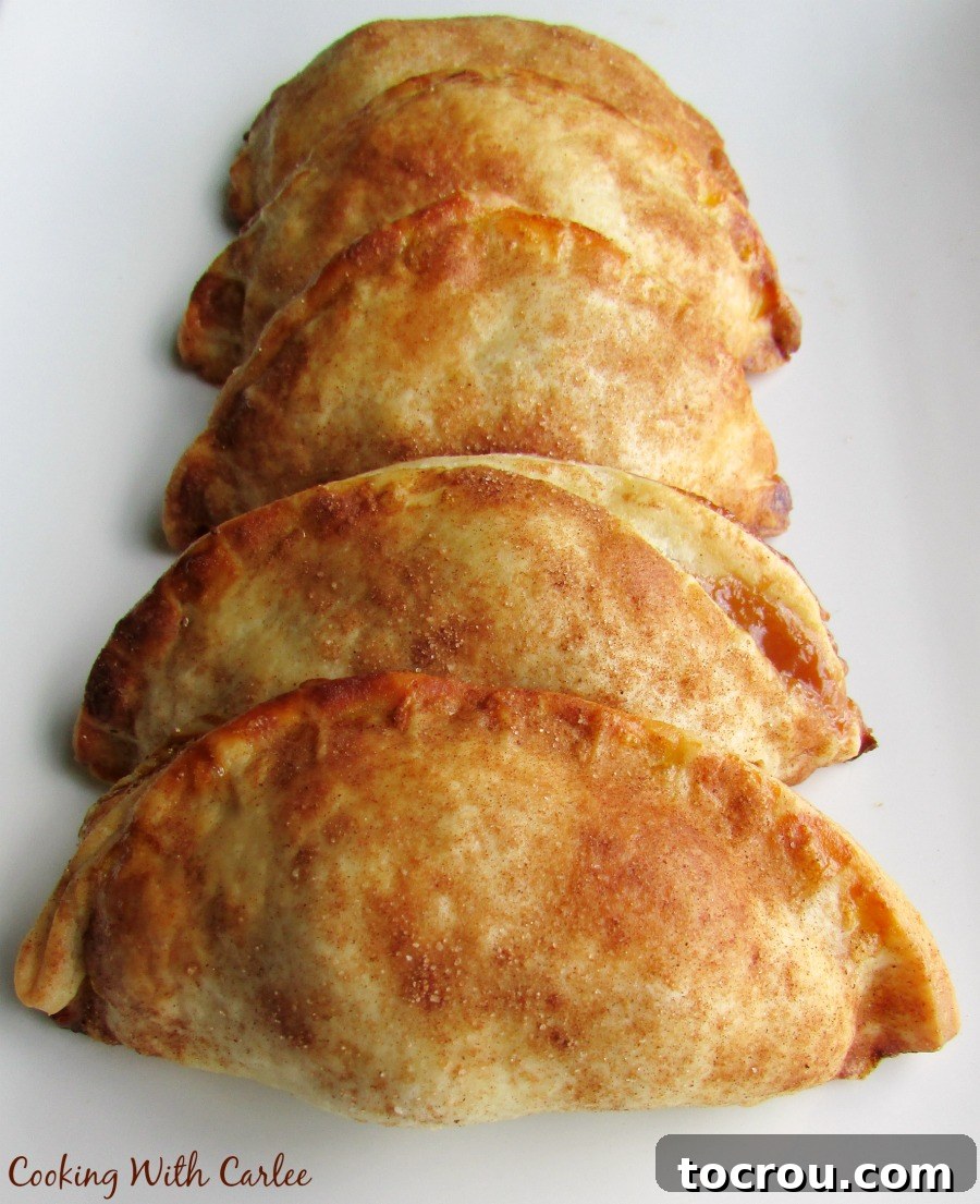 row of cajeta and apple empanadas on plate.