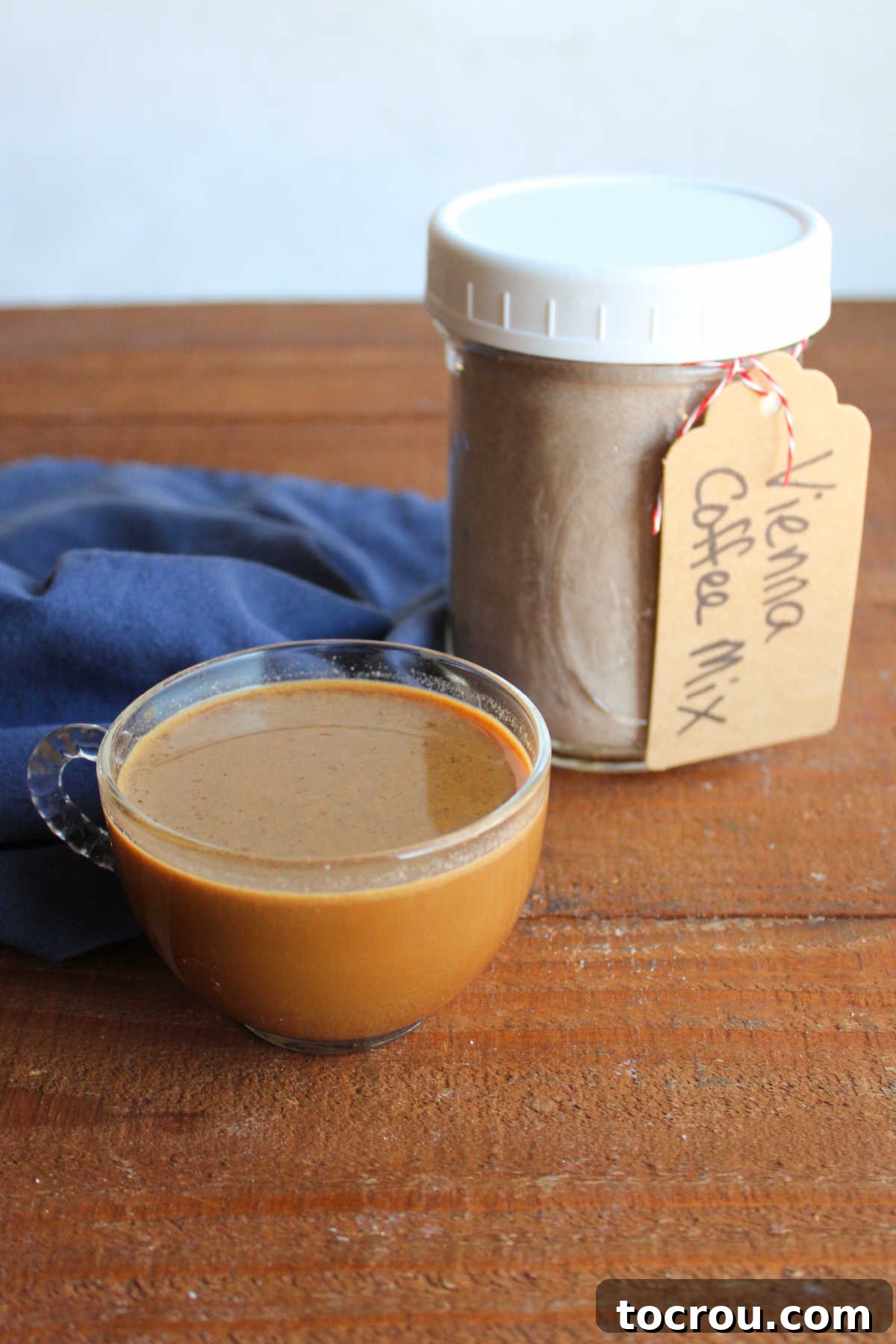 Viennese Coffee Ready to Enjoy Glass mug of viennese coffee next to a jar of the homemade mix.