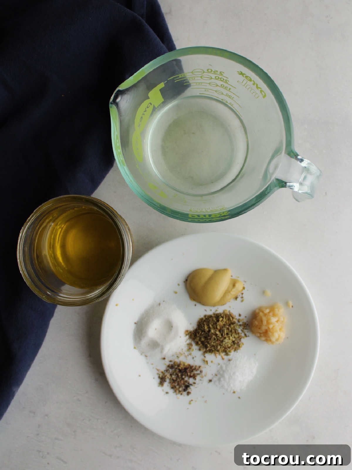 Chicago Chopped Salad Classic 5 Ingredients including olive oil, white wine vinegar, salt, pepper, oregano, sugar and dijon mustard ready to be made into vinaigrette.