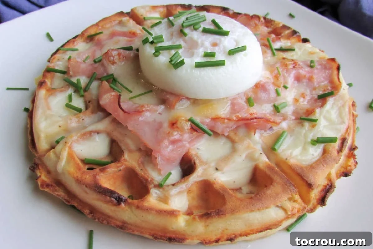Waffled Croque Madame 2 Ham and cheese waffle topped with creamy bechamel sauce, shaved ham, and melted cheese with a poached egg on top.