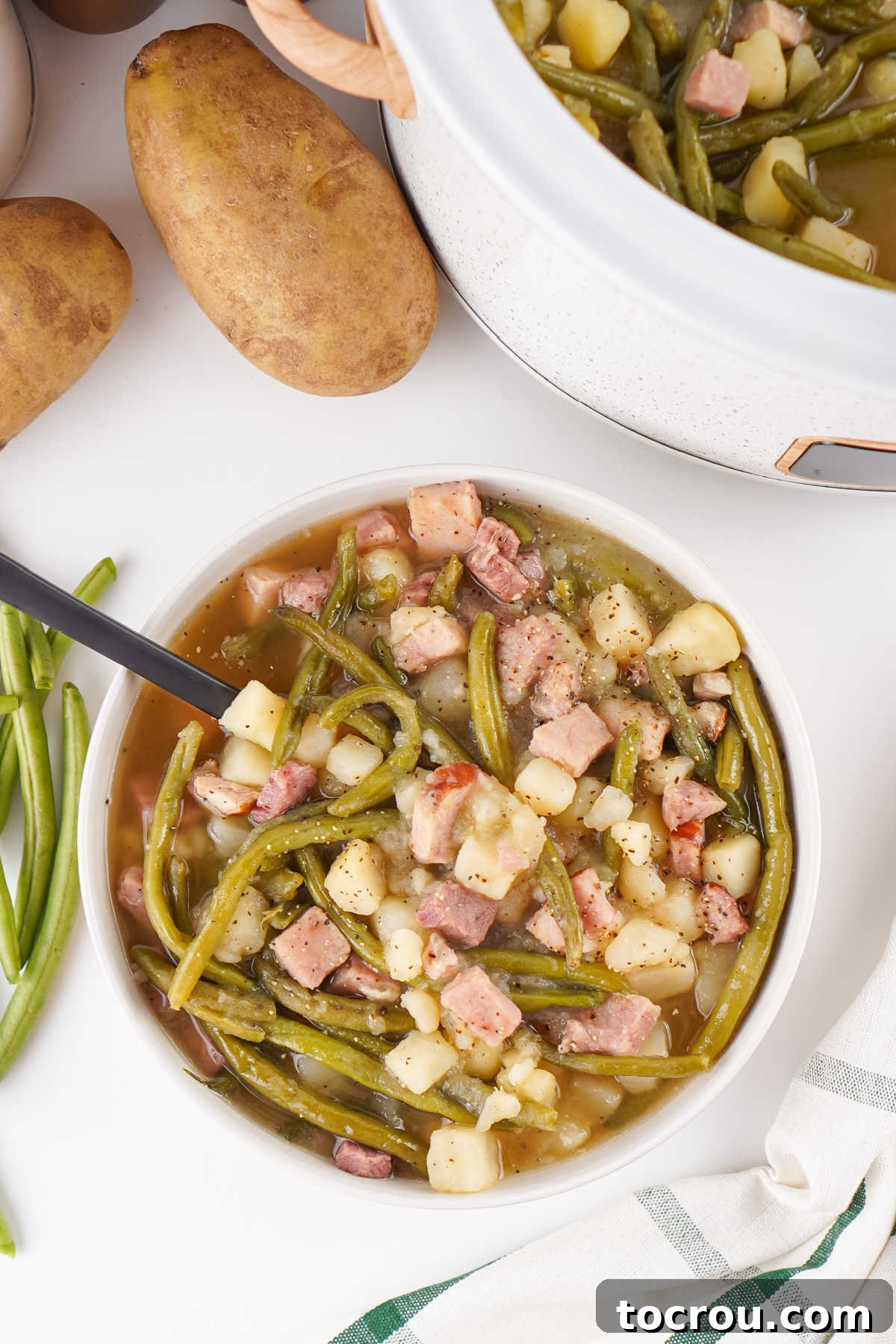 Southern Comfort Slow Cooker Ham Green Beans and Potatoes 4 Bowl of green beans with ham and potatoes, ready to eat.