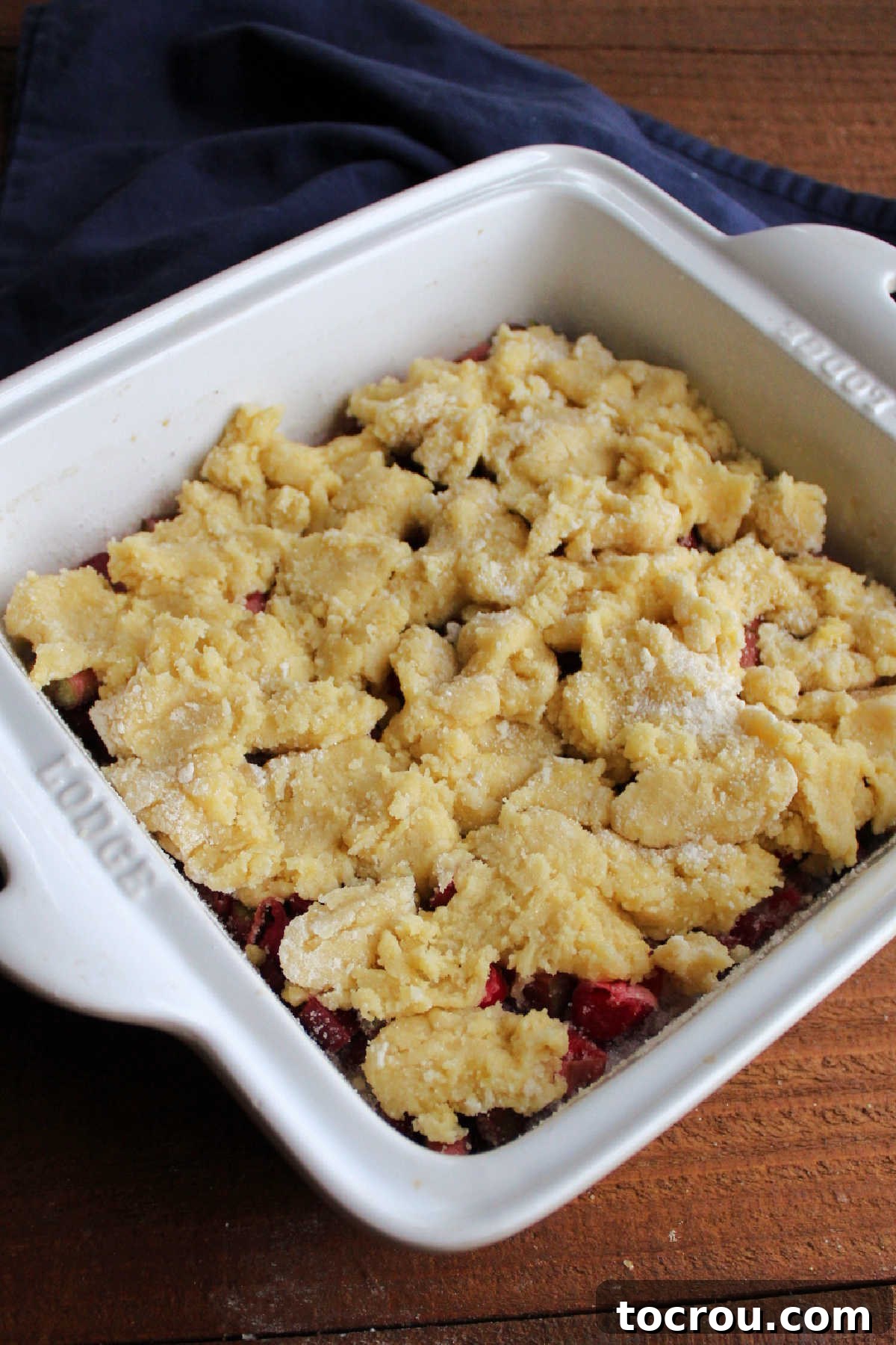 Dough dolloped on top of sugar and rhubarb, ready to go in the oven.