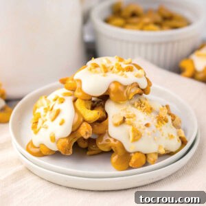 Clusters of cashews with homemade caramel and white chocolate on top, ready to eat.