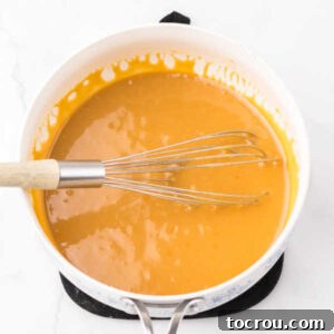 Pan of homemade sweetened condensed milk caramel for cashew clusters.
