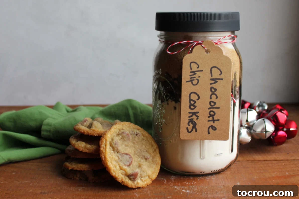 DIY Chocolate Chip Cookie Jar Mix 2 Stack of freshly baked chocolate chip cookies next to a jar of homemade cookie mix.