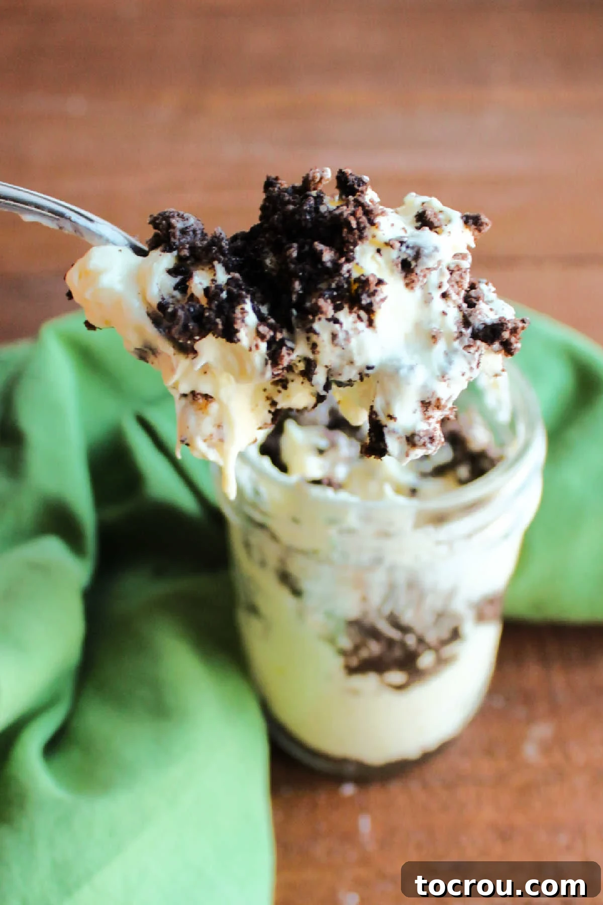 Serving Dirt Pudding Jar spoonful of dirt pudding being lifted out of jar.