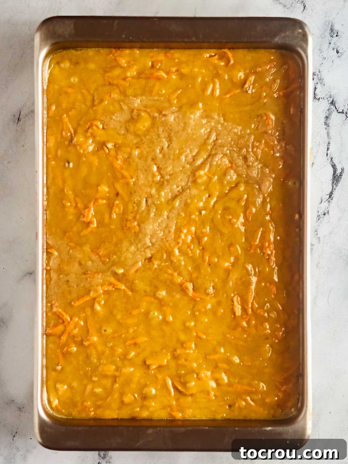 Irresistible Homemade Carrot Cake 6 Carrot cake batter in 9x13-inch pan, ready to go in the oven.