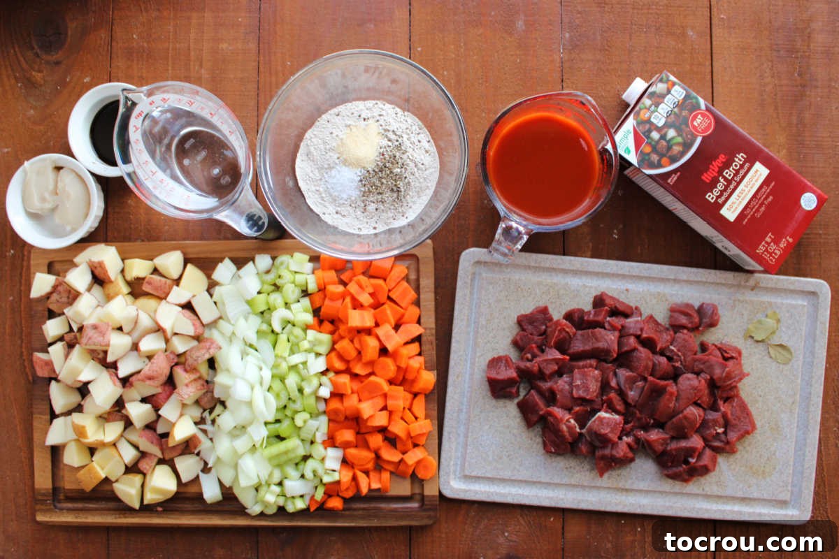 Venison Stew Ingredients A vibrant array of venison stew ingredients, including generous chunks of deer roast, fresh carrots, a large onion, celery stalks, diced potatoes, rich beef broth, spicy V-8 juice, water, all-purpose flour, a blend of seasonings, Worcestershire sauce, and flavorful bacon grease, laid out and ready for preparation.